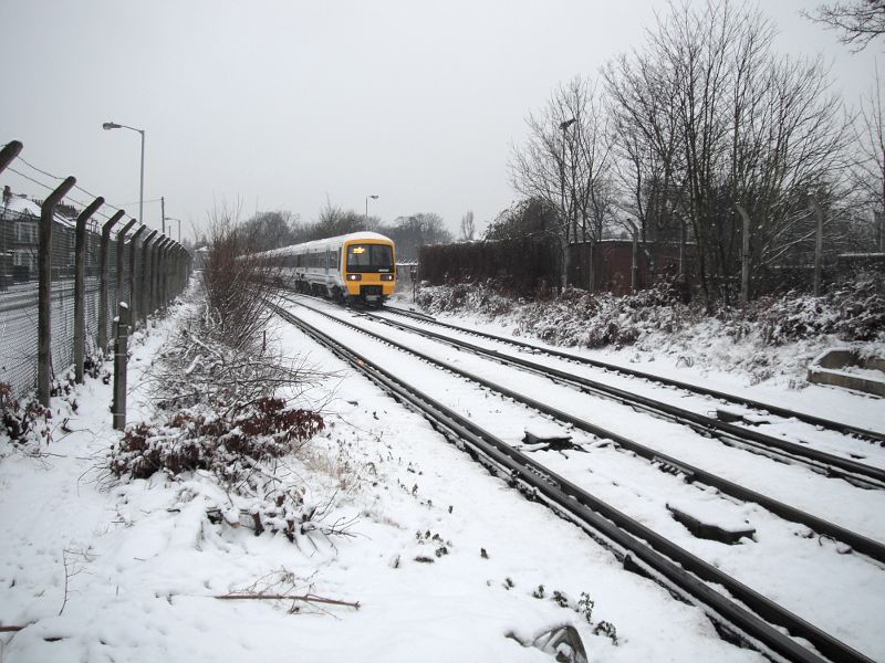 a train leaving Catford Bridge station proving that some trains do work in the snow