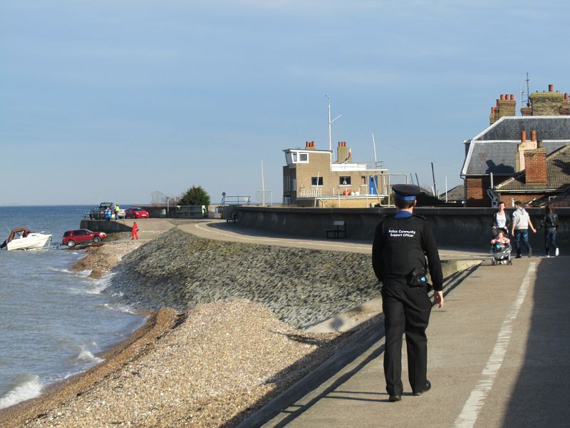 Community support policeman patrols the shore