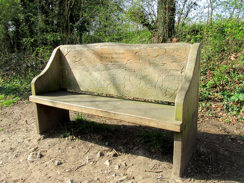 carved seat back alongside the river near Eynsford