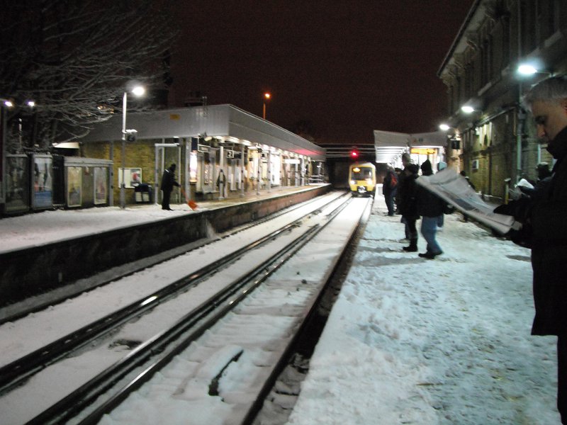 Catford Bridge -the 06:33 arrives on time despite the weather.