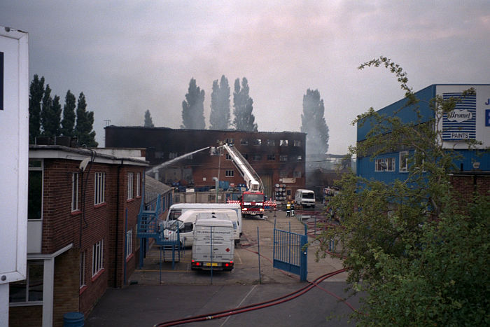 Main entrance of Bolloms
                  paint factory as the fire brigade finishes putting out
                  the fire that closed the place down