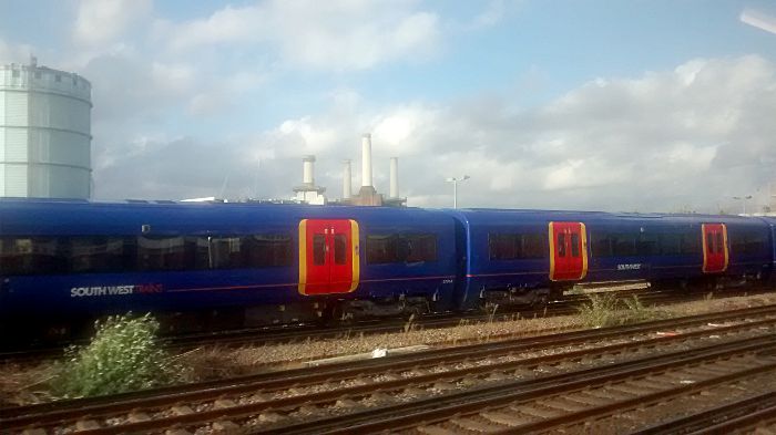 Battersea Power Station seen
                  through the dirty windows of a train