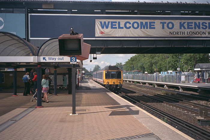 class 117 DEMU at
                      Kensington Olympia running the Clapham Junction to
                      Wilseden Junction service