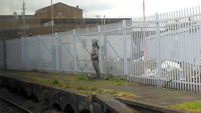 solitary bronze figure on the remains
                          of the disused platform