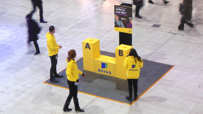 Aviva flogging their wares
                  on the concourse of Waterloo station