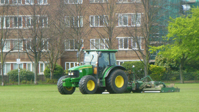 A tractor cutting
                            the grass in King Georges Park