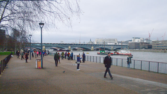 looking upstream along the south bank towards
                  Blackfriars station/railway bridge