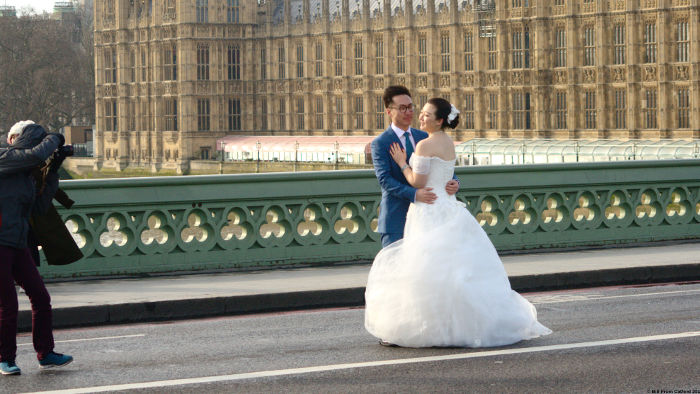 Asian bride posing
                            on Westminster Bridge