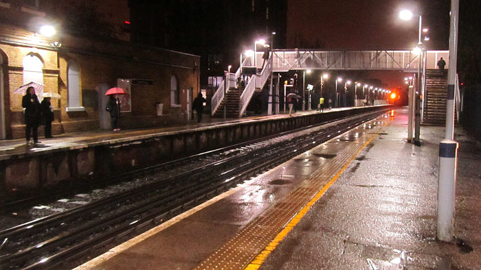 A wet and soggy platform 1 seen from near the
                  entrance on platform 2 of Catford Bridge