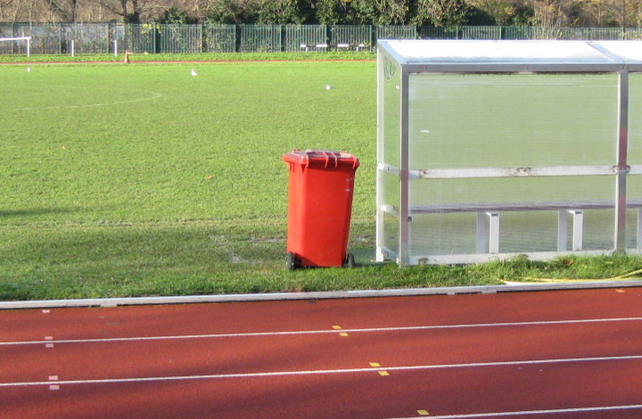 red wheelie bin by the
                        race track