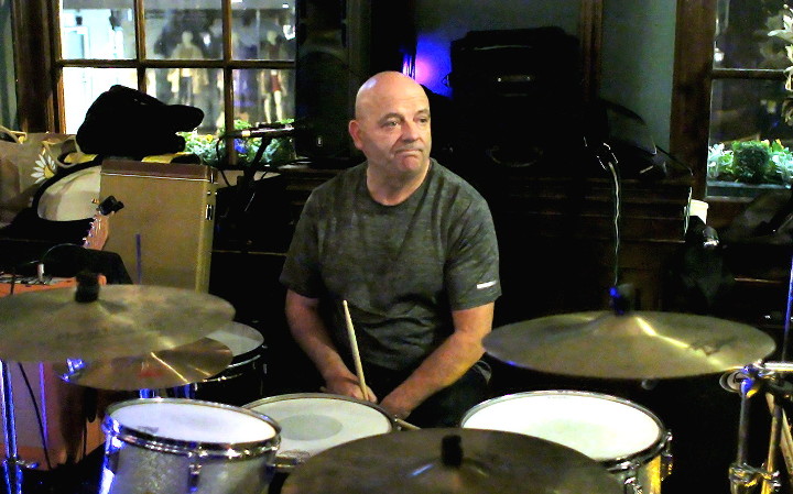 John Sutcliff the
                        drummer waiting for someone to tune up before
                        playing