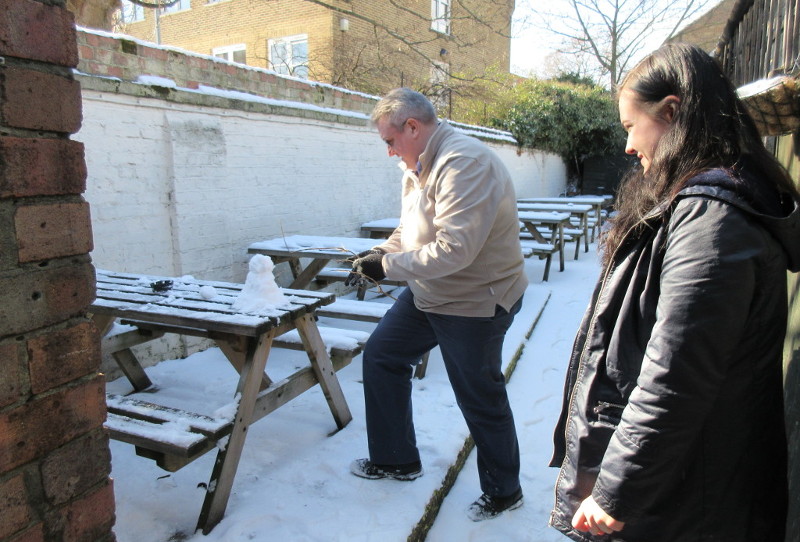 Building a small snowman in the garden of
                      the pub