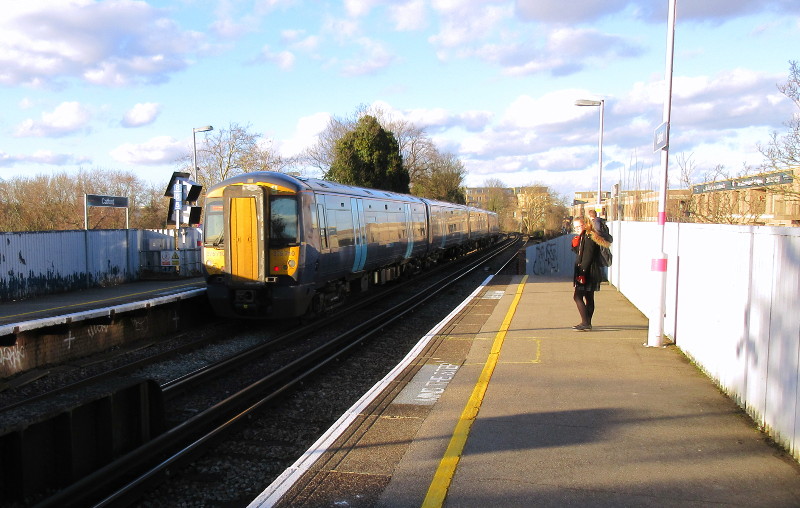 class 375 train speeding through the
                          station on it's way to Victoria