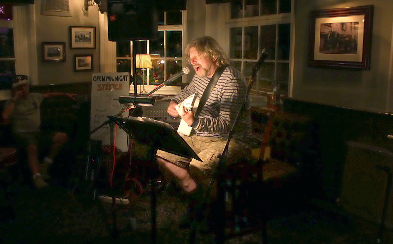 Simon Whitestar only
                        lit by the light on the music stand