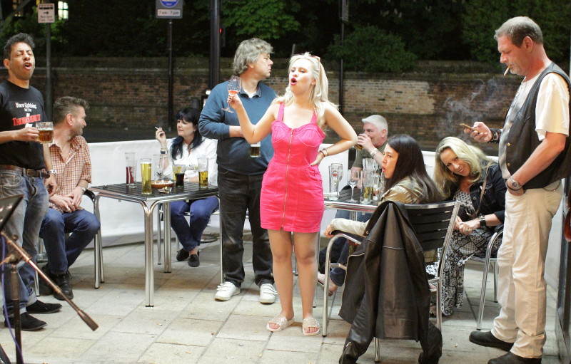 Carrie singing out the front of the pub