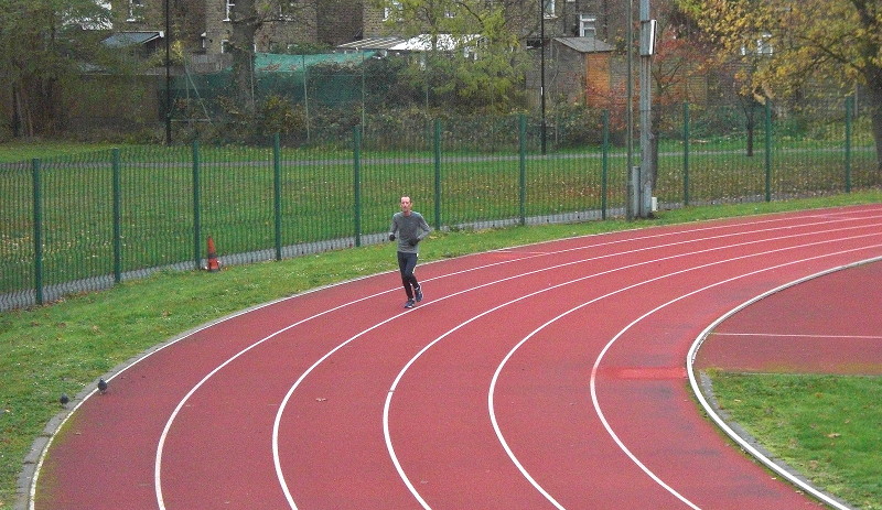 solitary athlete on
                        the running track