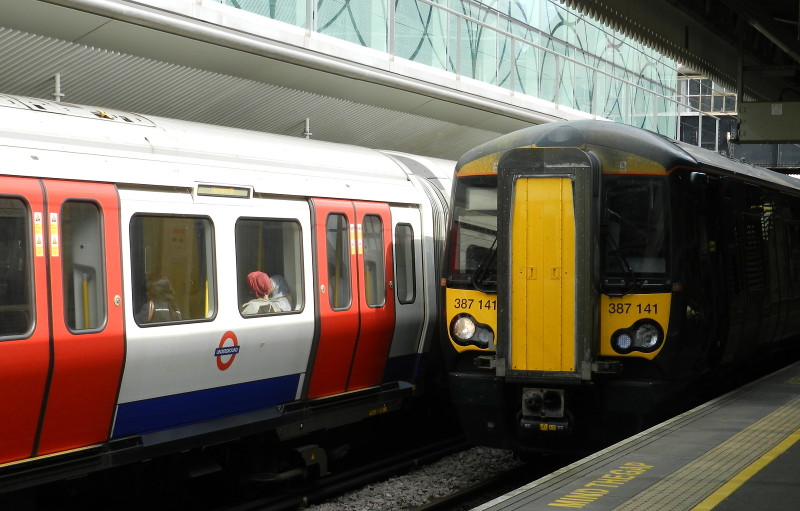 Underground and
                        National Rail train side by side