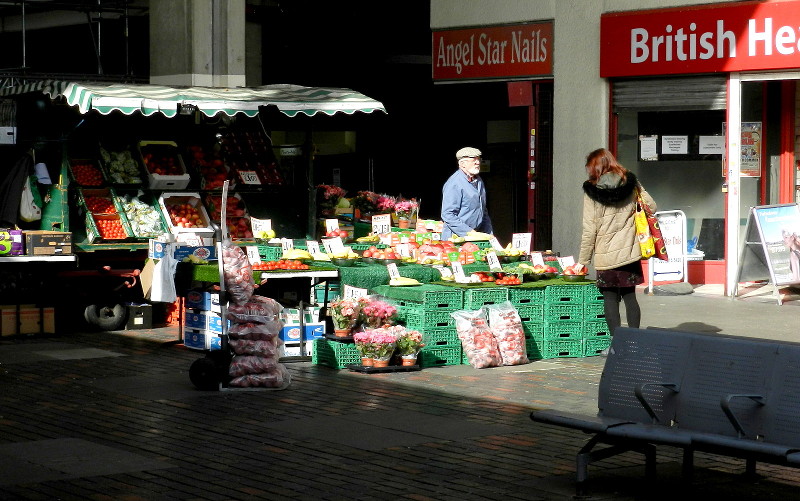 market stall in bright
                        sunshine and deep shadow