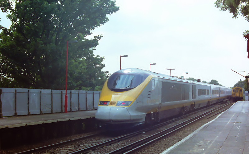 Eurostar train passes a slam door train at
                      Catford station