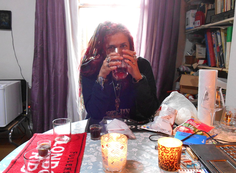 Jodie
                                      hiding behind a glass of
                                      "nordic berries" cider