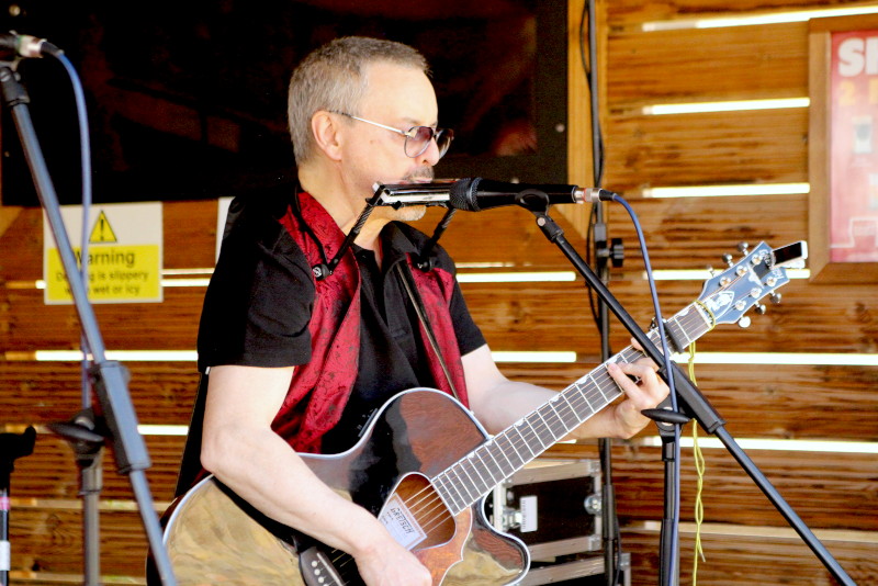 Francis playing harp and
                                          guitar